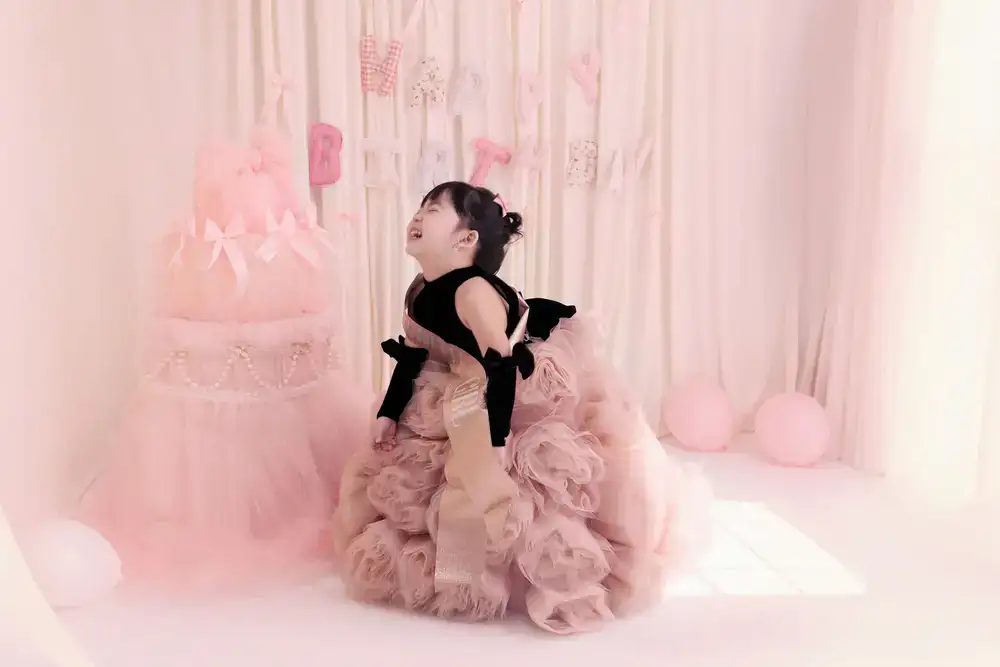 Birthday cake being brought out to a smiling child
