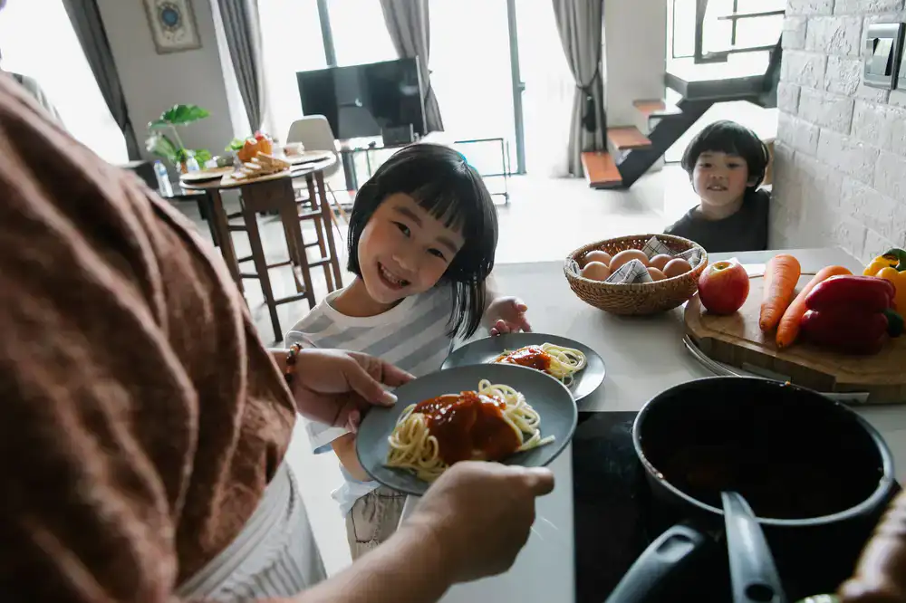 Party host serving food to happy kids